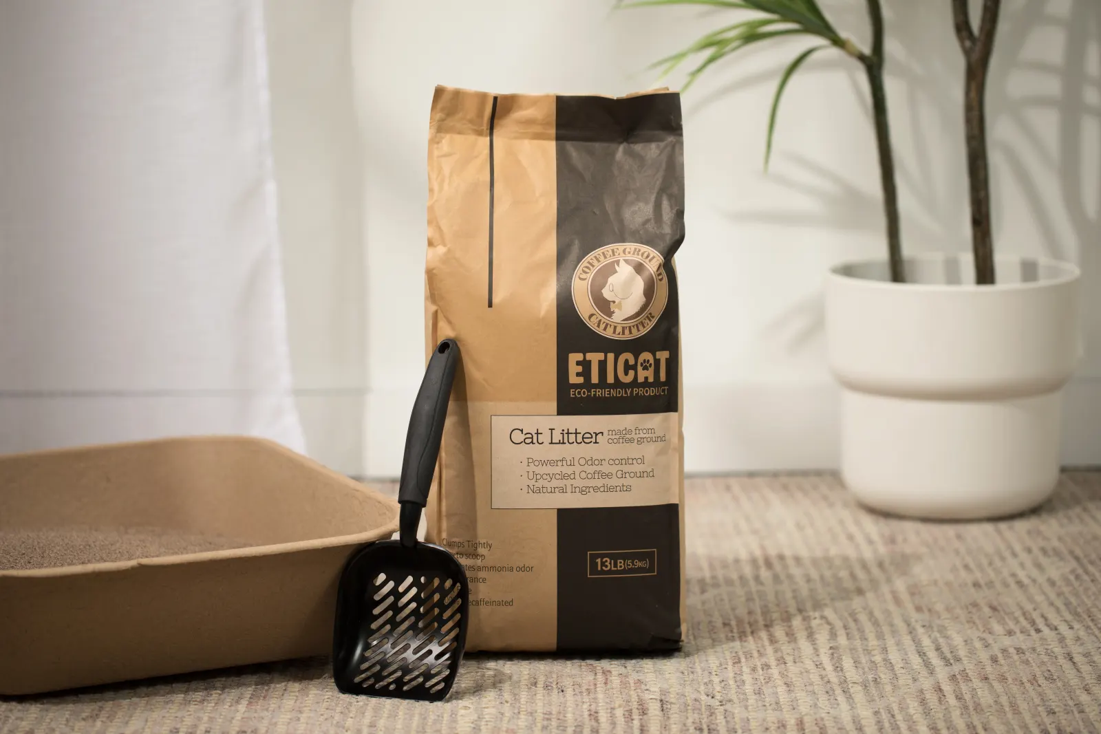 ETICAT+ 13 lb package standing beside a paper litter tray and a scoop