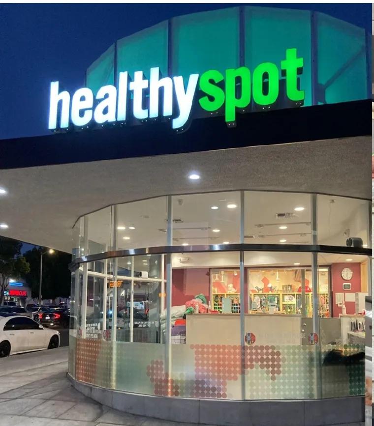 Illuminated Healthy Spot store exterior at night, California